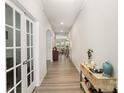 Bright hallway showcasing the home's open layout and elegant archway, leading to a spacious living area at 15636 Oleander Dr, Charlotte, NC 28278