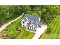 Aerial view of new construction home with a landscaped yard and private driveway at 16112 Terry Ln, Huntersville, NC 28078