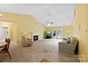Cozy living room with vaulted ceilings, fireplace, and access to the patio at 1958 Cameron Heights Cir, Denver, NC 28037