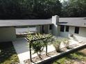 Aerial view of a large backyard featuring a patio, a covered area, and landscaping at 209 Falcon Dr, Concord, NC 28025