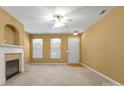 Bright living room with neutral walls, modern ceiling fan and cozy fireplace at 212 Township Dr, Fort Mill, SC 29715