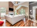 Spacious living room with vaulted ceiling, brick fireplace, hardwood floors, and ample natural light at 2133 Highland View Ln, Charlotte, NC 28214