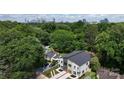 Stunning aerial view of modern home with city skyline in the background, surrounded by lush greenery at 2733 Cowles Rd, Charlotte, NC 28208