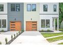 The exterior of the home features modern garage doors and varied siding, creating an aesthetically pleasing facade at 2733 Cowles Rd, Charlotte, NC 28208