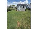 View of the backyard shed offering practical outdoor storage, set in a green, fenced lawn at 2810 Shumard Dr, Gastonia, NC 28054