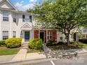 Inviting townhome featuring a brick facade, well-maintained landscaping, and a charming covered entrance at 3414 Broadwick St, Charlotte, NC 28213