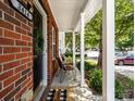 Covered porch with chairs, brick accents, and a welcoming entrance at 3414 Broadwick St, Charlotte, NC 28213