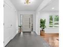 Bright foyer featuring slate floors, modern lighting, and views into the adjoining rooms at 3701 Table Rock Rd, Charlotte, NC 28226