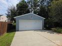Side view of a detached two car garage with ample parking on a sunny day at 4032 Wilgrove Way Dr # 252, Charlotte, NC 28213