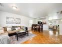 Inviting living room features hardwood floors, a plush couch, and a dining area perfect for gatherings at 4068 Sherri Ln, Fort Mill, SC 29715