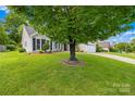 Landscaped front yard with a large shade tree, lush lawn and inviting curb appeal at 4313 Wynborough Ln, Charlotte, NC 28269