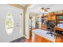 Inviting home office with hardwood floors, a large wooden desk, custom built-ins, and lots of natural light at 4313 Wynborough Ln, Charlotte, NC 28269