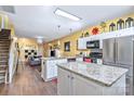 Open kitchen with stainless steel appliances, granite countertops, and center island overlooking the living area at 460 Clouds Way, Rock Hill, SC 29732