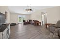 Open living room with durable laminate flooring, neutral color palette, and french doors to the yard at 5445 Creekwood Dr, Salisbury, NC 28147