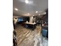 Open-concept kitchen with large island, stainless steel appliances, and hardwood floors at 5707 S Rocky River Rd, Monroe, NC 28112
