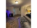 Main bedroom with accent lighting, plush carpeting, area rug, and closet access at 5707 S Rocky River Rd, Monroe, NC 28112