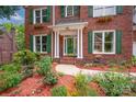 Close-up of home's entry with detailed landscaping, green shutters, and a welcoming front porch at 6016 Graburns Ford Dr, Charlotte, NC 28269