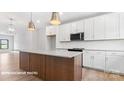 Spacious kitchen with white cabinets and a large center island at 732 Falling Oak Aly # 22, Huntersville, NC 28078
