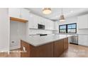Bright kitchen featuring a large island, white cabinetry, and stainless appliances at 732 Falling Oak Aly # 22, Huntersville, NC 28078