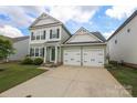Charming home featuring an attached two car garage and a well-kept lawn at 903 Von Buren Blvd, Rock Hill, SC 29730