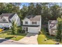 Lovely aerial view of a quaint home with a two-car garage and a combination of stone and siding at 2532 Blue Moss Dr, Dallas, NC 28034