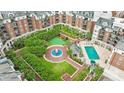 Beautifully landscaped condo courtyard with a pristine pool, putting green, and serene water feature at 300 W 5Th St, Charlotte, NC 28202