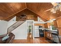 Eat-in kitchen with wood ceiling, cabinetry and appliances adjacent to the living area at 360 Lake Landing Dr, Salisbury, NC 28146