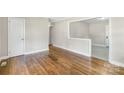 Spacious living room features hardwood floors and a view into the dining area at 4413 Tillman Rd, Charlotte, NC 28208