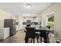 Bright kitchen with stainless steel appliances, white cabinets, and a cozy eat-in dining area at 473 Wendover Dr, Salisbury, NC 28147