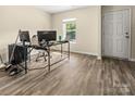 A functional office space with wood-look floors, natural light, and easy access to an exterior door at 473 Wendover Dr, Salisbury, NC 28147