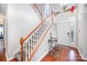 Inviting foyer with hardwood floors, staircase, large window providing natural light, and a front door at 4835 Chesney Nw St, Concord, NC 28027