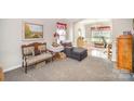 Cozy living room with plush carpeting, decorative furnishings, and bright windows at 4835 Chesney Nw St, Concord, NC 28027