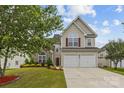 Traditional two-story home featuring a stone facade, vinyl siding, and manicured lawn at 516 Cool Creek Dr, Rock Hill, SC 29732