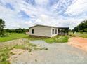Single-story home featuring vinyl siding, dark shutters, and small front porch at 5321 State Line Rd, Marshville, NC 28103