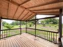 Spacious covered porch with wood flooring, offering picturesque outdoor views at 5321 State Line Rd, Marshville, NC 28103