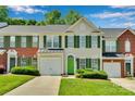 Attractive townhome with a green door, matching shutters, and well-maintained landscaping at 6000 Boathouse Ln # C, Cramerton, NC 28032