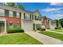 Street view of townhomes with green shutters, manicured lawns, and attached garages at 6000 Boathouse Ln # C, Cramerton, NC 28032
