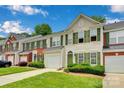 Attractive townhome featuring green shutters, well-manicured lawn, and an attached garage at 6000 Boathouse Ln # C, Cramerton, NC 28032