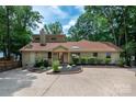 Charming home with a well-maintained lawn, beautiful landscaping, and a spacious concrete driveway at 6259 River Cabin Ln, Charlotte, NC 28278