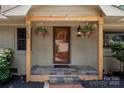 Charming front porch with decorative hanging plants and a welcome mat at 6259 River Cabin Ln, Charlotte, NC 28278