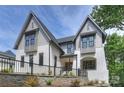 Beautiful two-story home with white brick, gray siding, black trim, and manicured landscaping at 7011 Chateau Bordeaux Ln, Charlotte, NC 28270