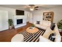 Bright living room with hardwood floors, fireplace, flatscreen TV, and comfy seating area at 7812 Old Concord Rd, Salisbury, NC 28146