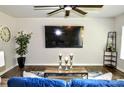 Stylish living room featuring a large screen TV, modern decor, and wood flooring at 8388 Waxhaw Hwy, Waxhaw, NC 28173