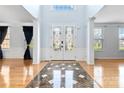 Grand foyer with hardwood floors, decorative tile inlay, and elegant double doors at 1009 Murandy Ln, Matthews, NC 28104