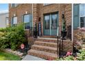 Inviting brick front porch with double doors, decorative plants, and 'Welcome' sign at 1009 Murandy Ln, Matthews, NC 28104