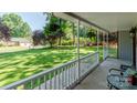 Relaxing view from the front porch to the manicured lawn with mature trees and landscape and outdoor seating at 110 Club Dr, Mooresville, NC 28115
