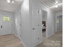 Inviting hallway with neutral paint, wood-look flooring, and easy access to multiple bedrooms at 11329 Torino Rd, Matthews, NC 28105