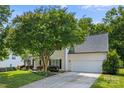Traditional home with a well-manicured lawn and a two-car garage at 129 Nims Spring Dr, Fort Mill, SC 29715
