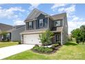 Charming two-story home with blue and gray siding, a well-manicured lawn, and a two-car garage at 12912 Canterbury Castle Dr, Charlotte, NC 28273