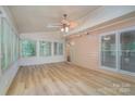 Inviting sunroom with wood floors, ample natural light, neutral walls, and a ceiling fan at 140 Rustic Way Ln, Mooresville, NC 28117
